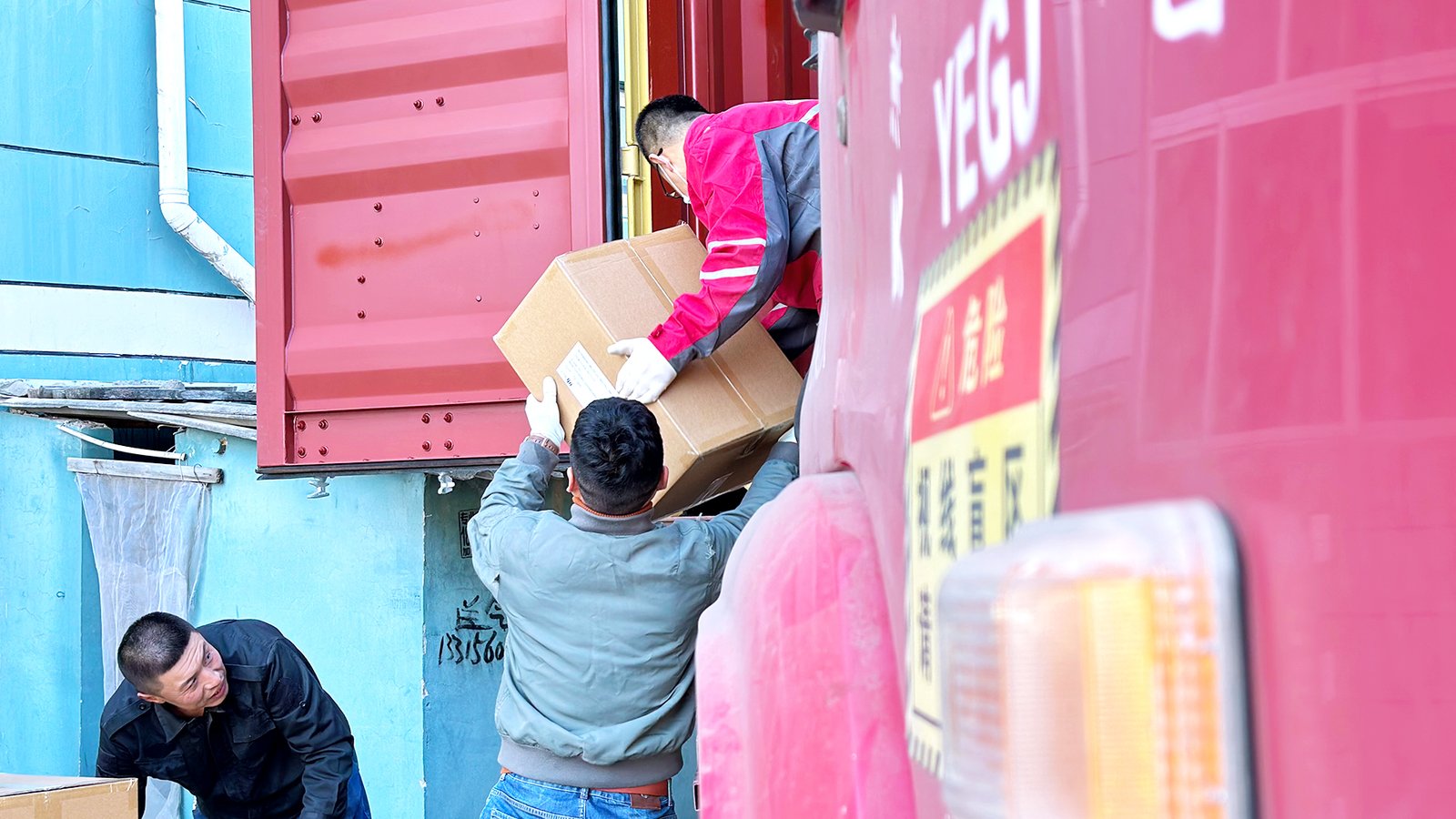 Workers loading packed percussion instruments orders for shipment